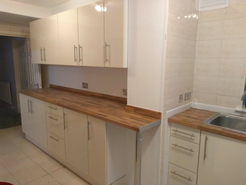 Fitted kitchen with cream cabinets and solid wood worktops
