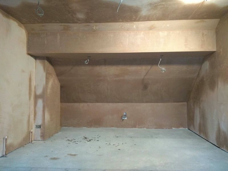 Loft room with freshly skimmed walls and sloping ceiling drying out