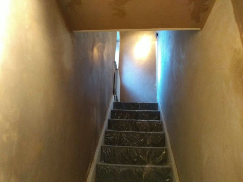 Narrow staircase with newly plastered walls