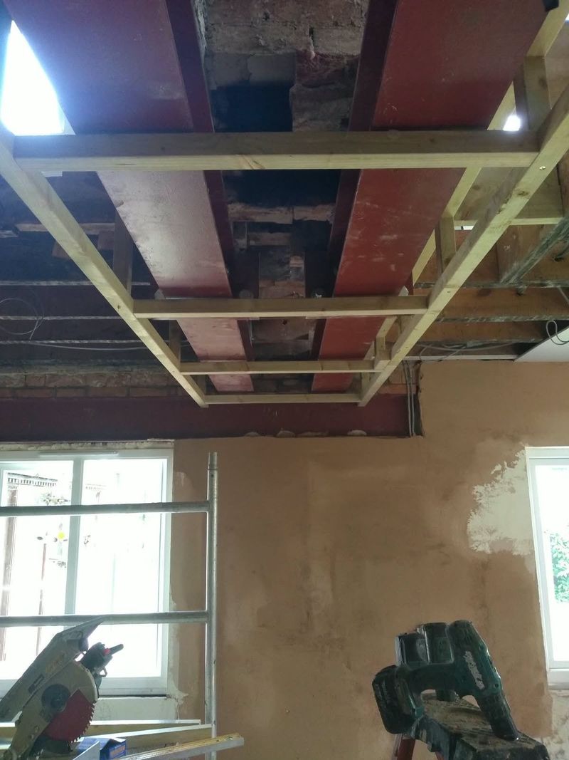 New steel beams and timber ceiling joists fitted during a structural alteration